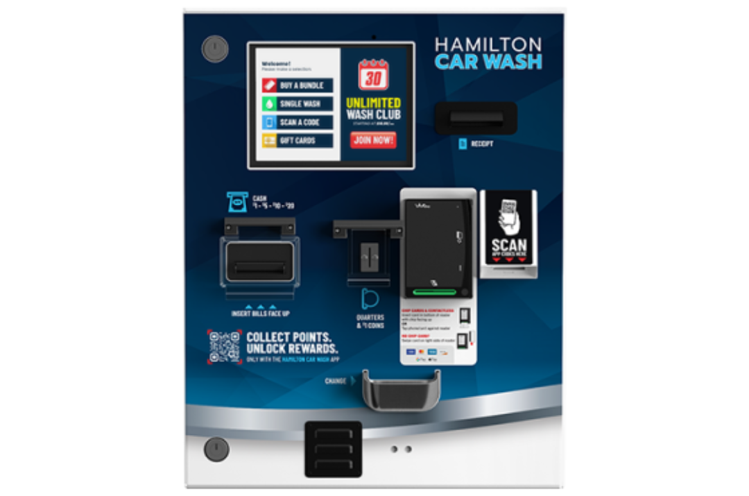 Hamilton <strong> Manufacturing </strong> A black SUV is being sprayed with blue water jets inside an automated car wash bay.