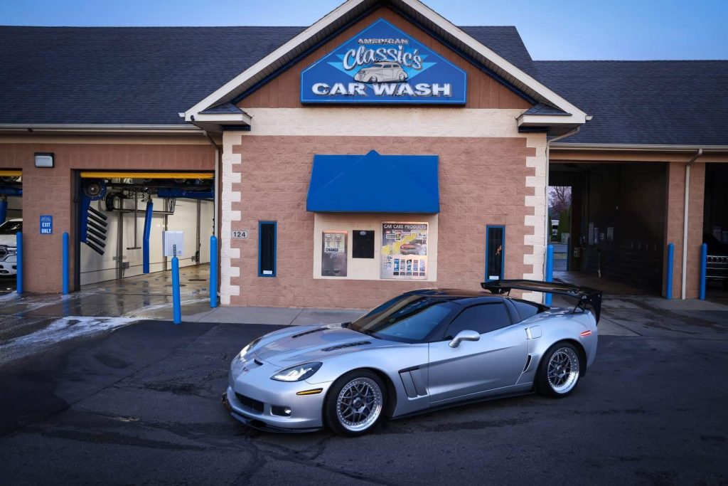 American Classic's Car Wash Finds Success with the Petit Accutrac®360-i A silver sports car is parked in front of a car wash building with blue accents and signage reading "American Classic Car Wash.